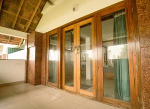 a room with glass doors in a building at 36 Palms- Sun and Sand in Cochin +43 photos