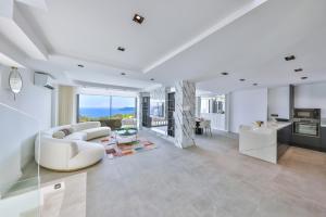 a living room with a white couch and a table at Villa Sky Line - Private Pool - Panoramic Sea View in Kaş