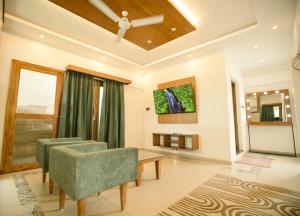a living room with two chairs and a table at 36 Palms- Sun and Sand in Cochin