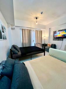 a living room with two beds and a couch at D' Cozy Pines Suites in Baguio