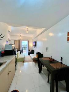a kitchen and a living room with a table at D' Cozy Pines Suites in Baguio +15 photos
