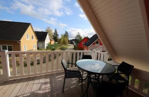 a balcony with a table and chairs on it at Roter Blitz 2 k108 in Röbel