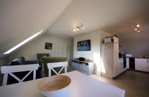 a kitchen and living room with a white refrigerator at Roter Blitz 2 k108 in Röbel