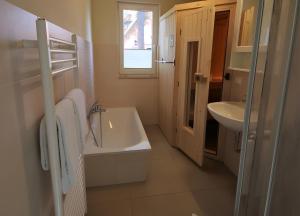 a bathroom with a sink and a bath tub at Roter Blitz 2 k108 in Röbel +16 photos