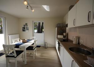 a kitchen with a table and chairs and a sink at Roter Blitz 2 k108 in Röbel