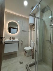 a bathroom with a toilet and a sink and a shower at Prenoćište Lovac in Prijepolje +4 photos