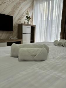 a bedroom with a bed with a towel on it at Prenoćište Lovac in Prijepolje