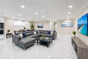 a living room with a couch and a table at Premium Luxury 5BR Villa near Hollywood Beach in Hollywood
