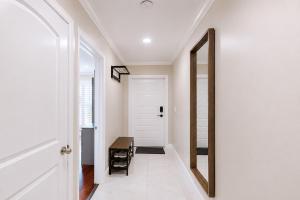 a hallway with a mirror and a door with a table at Premium Luxury 5BR Villa near Hollywood Beach in Hollywood +36 photos