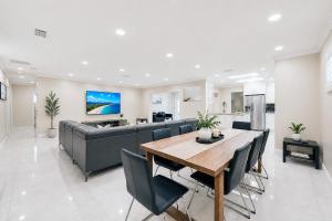 a living room with a table and a couch at Premium Luxury 5BR Villa near Hollywood Beach in Hollywood