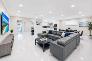 a living room with a couch and a table at Premium Luxury 5BR Villa near Hollywood Beach in Hollywood