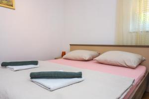 a bed with two pillows on top of it at Medo in Novigrad Istria