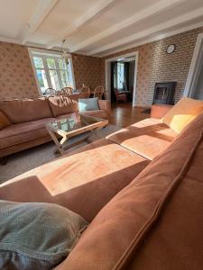 a living room with several couches and a table at Lofoten Town Villa I Sleeps 9 in Leknes