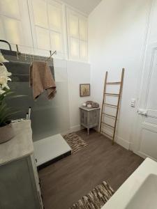 a room with a ladder and a table and a shelf at La belle époque ardennaise in Sedan +34 photos