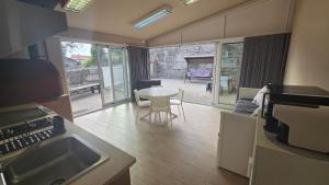 a kitchen with a table and a view of a patio at Fernandes House in Paredes de Coura