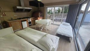 a room with two beds and a kitchen with a table at Fernandes House in Paredes de Coura +45 photos