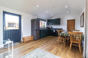 a kitchen and dining room with a table and chairs at The Stables in Sibbertoft