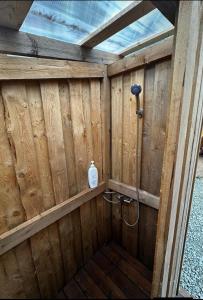 a wooden bathroom with a shower in a wooden wall at Miami Jungle Glamping Experience in Korjuse