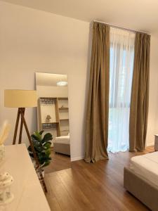 a living room with a bed and a window at Foel Apartament in Tirana