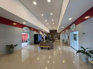 a lobby of a building with a bench in the middle at Flat 203 Red Sorocaba in Sorocaba +31 photos