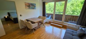 a living room with a wooden table and chairs at Zimnitzblick in Haiden