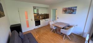 a living room with a table and a kitchen at Zimnitzblick in Haiden