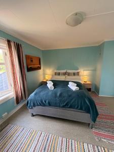 a bedroom with a bed with two towels on it at Lofoten Town Villa I Sleeps 9 in Leknes