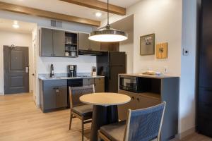 a kitchen with a table and chairs and a kitchen with a table and a counter at EBAC Moab in Moab