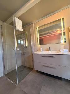 a bathroom with a shower and a sink at Lofoten Town Villa I Sleeps 9 in Leknes +32 photos