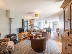 a living room with a couch and a fireplace at 4 Bed in Holsworthy oc-77663 in Milton Damerel