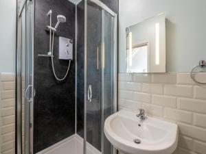 a bathroom with a shower and a sink and a shower at 4 Bed in Holsworthy oc-77663 in Milton Damerel +27 photos