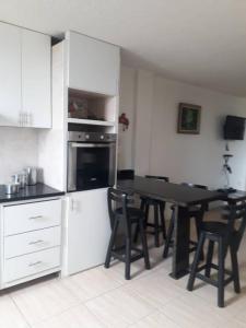 a kitchen with a table and chairs in a kitchen at Vilma's BnB in Mérida