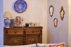 a room with a wooden dresser with blue and white plates at Dar Halima in Rabat