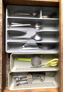 a drawer full of utensils in a wooden box at Studio Léman in Chambéry