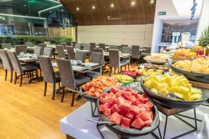 a buffet of fruit on tables in a restaurant at Biohotel Organic Suites Bogotá Usaquén in Bogotá
