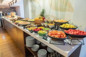 a buffet line with many different fruits and vegetables at Biohotel Organic Suites Bogotá Usaquén in Bogotá