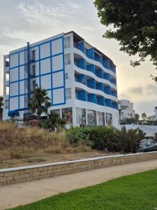 a building with blue windows on the side of a road at Cabo dream 75 piscine et wifi in Cabo Negro +3 photos