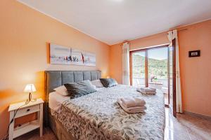 a bedroom with a bed and a large window at Villa Castello in Korčula +81 photos