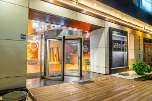 an entrance to a building with a revolving door at Biohotel Organic Suites Bogotá Usaquén in Bogotá