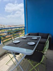 a table and chairs on a balcony with a view at Cabo dream 75 piscine et wifi in Cabo Negro