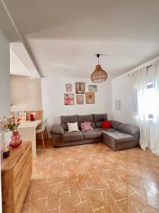 a living room with a couch and a table at Patio del recuerdo in Benalup Casas Viejas +5 photos