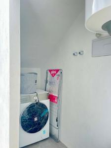a small refrigerator in a corner of a room at Patio del recuerdo in Benalup Casas Viejas