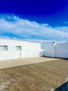 a white building with a sky in the background at Patio del recuerdo in Benalup Casas Viejas