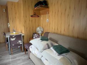 a living room with a couch and a table at Łąkowa Dolina - domek letniskowy in Supraśl