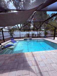 a large swimming pool with a canopy over it at Escape to Tropical Tampa in Tampa