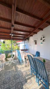 a patio with chairs and a table on a patio at Mimosa House Ayvalık in Ayvalık +15 photos