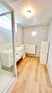 a white bathroom with a sink and a mirror at La Maison des Poutres & Lumières - Emile Zola in Croix +43 photos