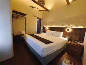 a bedroom with a large white bed and a mirror at El Balcón in Cusco +94 photos
