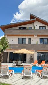 a villa with a swimming pool and some lounge chairs at Davos hotel and tours in Pʼarakʼar