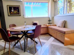 a dining room with a table and chairs and a window at Christina's Cottage in Agios Nikolaos